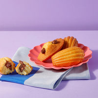 Thumbnail for Three of our delicious Choco-Hazelnut Madeleines served on a plate