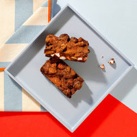 Thumbnail for An overhead view of our Rocky Road traybake slices on a square grey plate