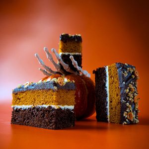 Chocolate praline pumpkin traycake with cream cheese icing and sprinkles – cakes for coffee shops UK