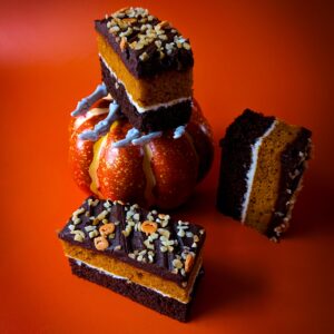 Close-up of chocolate praline pumpkin traycake slice showing praline layers – coffee shop cake supplier UK