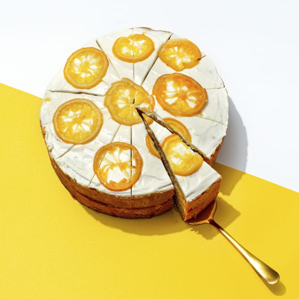 Cake Club's Lemon and Yuzu Cake on a yellow and white background with a cake slice.